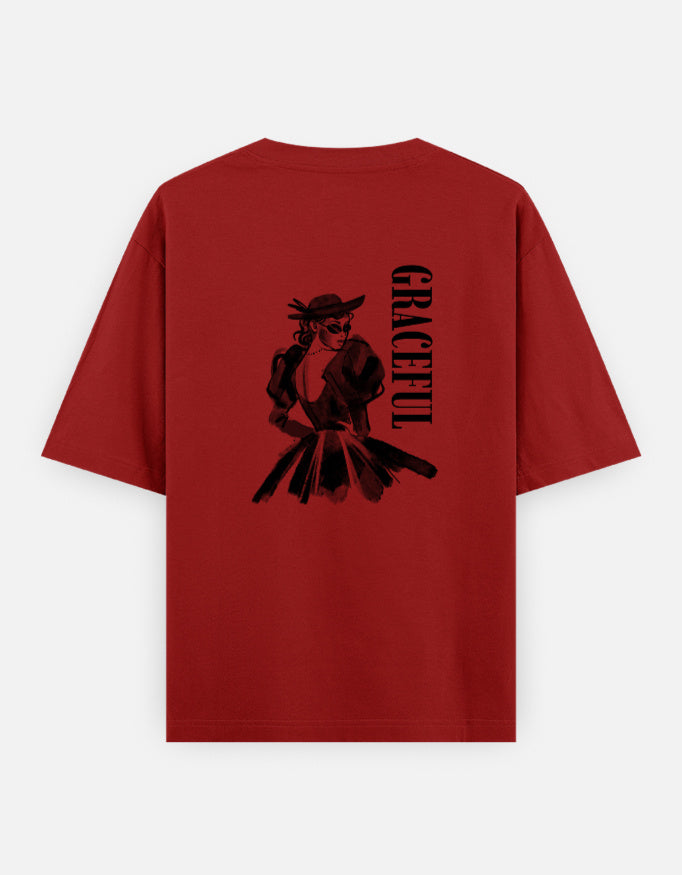 Red oversized unisex t shirt featuring a back print of a monochrome fashion illustration of a stylish woman wearing a hat and dress alongside vertical GRACEFUL typography. Made from premium 240 GSM 100% cotton with a relaxed oversized fit. Available in Black and Cream by Shisha.