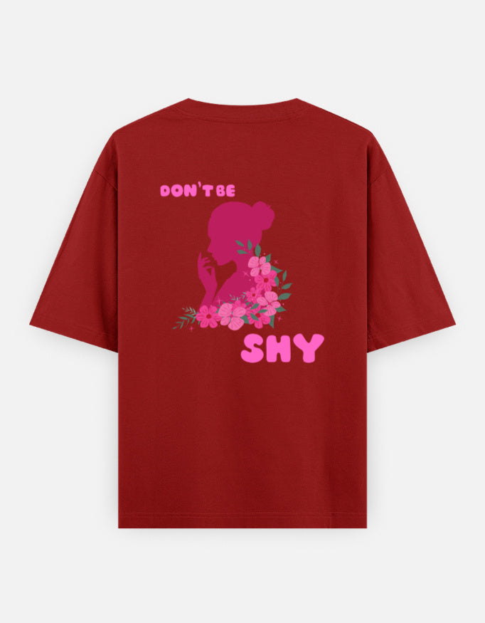 oversized unisex t shirt featuring a back print of a pink floral silhouette of a woman surrounded by blooming flowers with the words DON'T BE SHY.