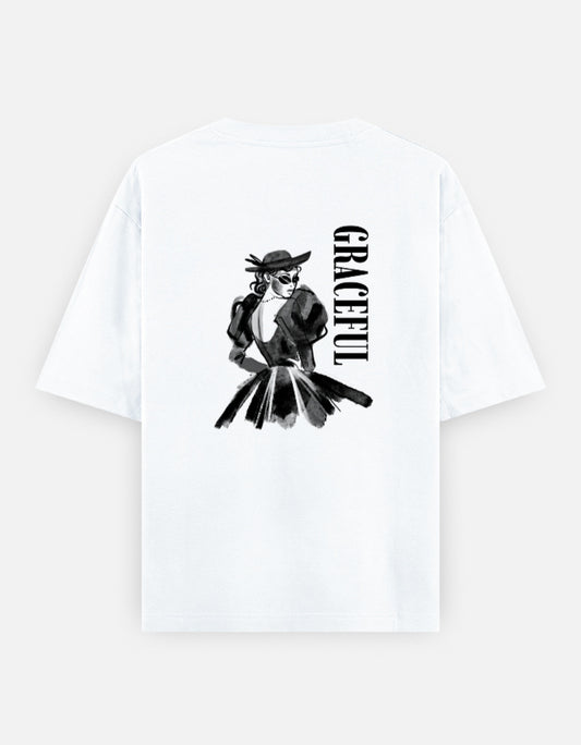 White oversized unisex t shirt featuring a back print of a monochrome fashion illustration of a stylish woman wearing a hat and dress alongside vertical GRACEFUL typography. Made from premium 240 GSM 100% cotton with a relaxed oversized fit. Available in Black and Cream by Shisha.