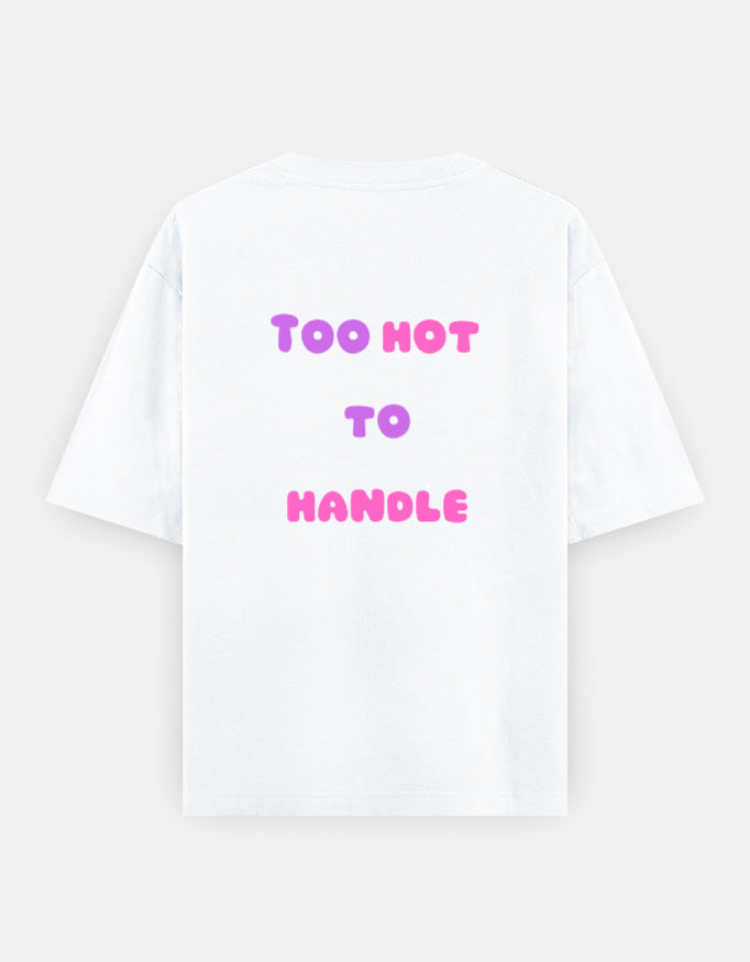 White oversized unisex t shirt featuring a back print with the phrase TOO HOT TO HANDLE in bold retro bubble typography with a pink and purple gradient. Made from premium 240 GSM 100% cotton with a relaxed oversized fit. Available in Black and Cream by Shisha.