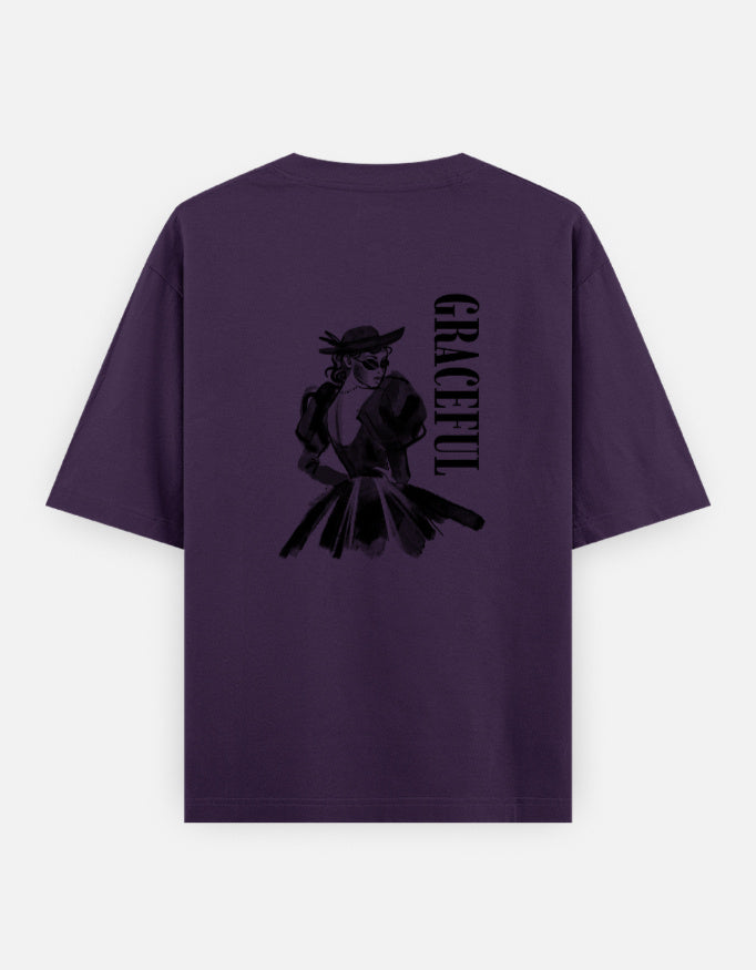 Purple oversized unisex t shirt featuring a back print of a monochrome fashion illustration of a stylish woman wearing a hat and dress alongside vertical GRACEFUL typography. Made from premium 240 GSM 100% cotton with a relaxed oversized fit. Available in Black and Cream by Shisha.