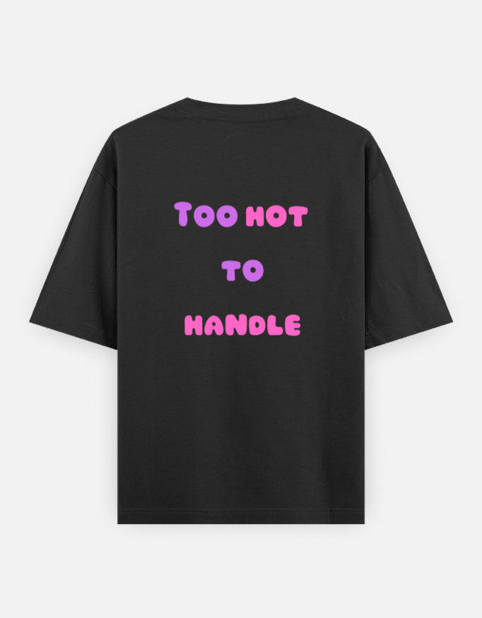 Black oversized unisex t shirt featuring a back print with the phrase TOO HOT TO HANDLE in bold retro bubble typography with a pink and purple gradient. Made from premium 240 GSM 100% cotton with a relaxed oversized fit. Available in Black and Cream by Shisha.