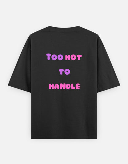 Black oversized unisex t shirt featuring a back print with the phrase TOO HOT TO HANDLE in bold retro bubble typography with a pink and purple gradient. Made from premium 240 GSM 100% cotton with a relaxed oversized fit. Available in Black and Cream by Shisha.