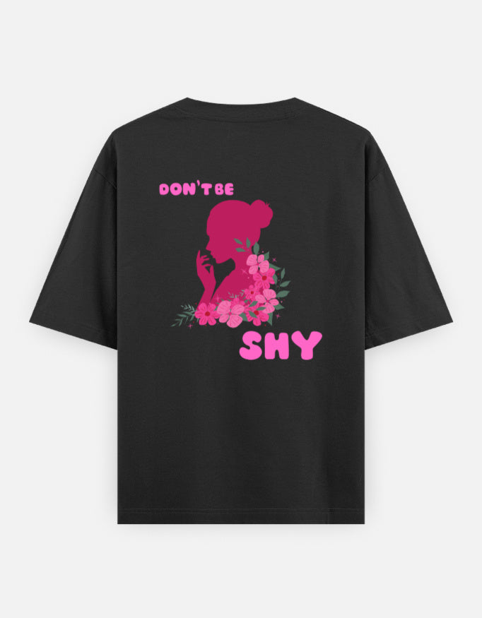 oversized unisex t shirt featuring a back print of a pink floral silhouette of a woman surrounded by blooming flowers with the words DON'T BE SHY.