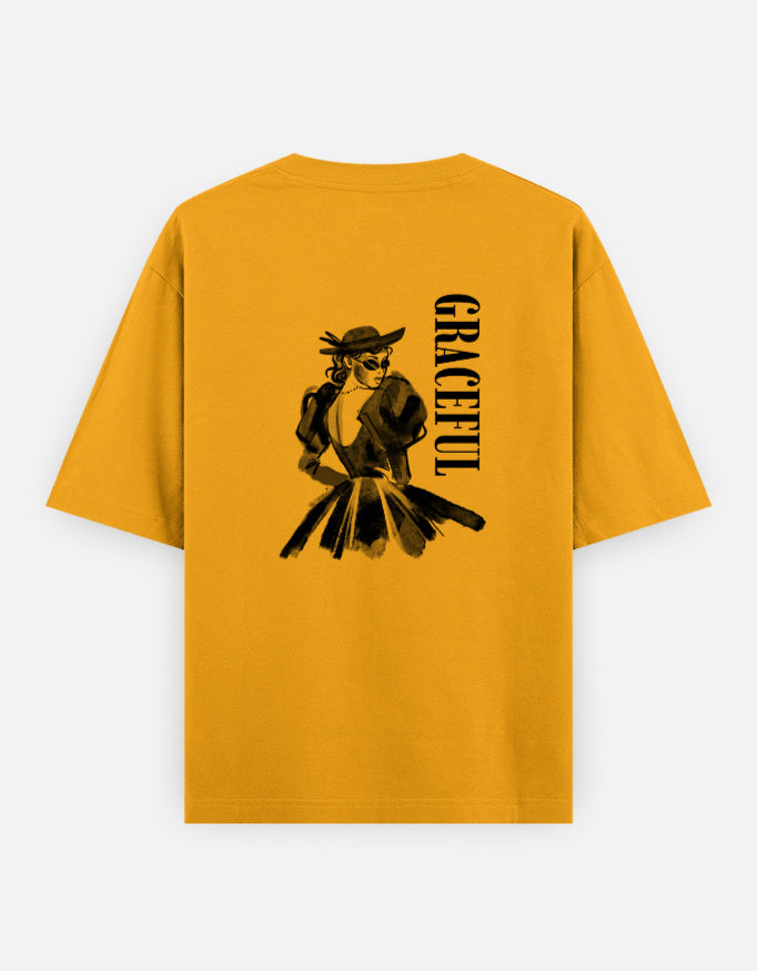 Yellow oversized unisex t shirt featuring a back print of a monochrome fashion illustration of a stylish woman wearing a hat and dress alongside vertical GRACEFUL typography. Made from premium 240 GSM 100% cotton with a relaxed oversized fit. Available in Black and Cream by Shisha.
