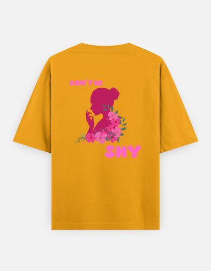 oversized unisex t shirt featuring a back print of a pink floral silhouette of a woman surrounded by blooming flowers with the words DON'T BE SHY.