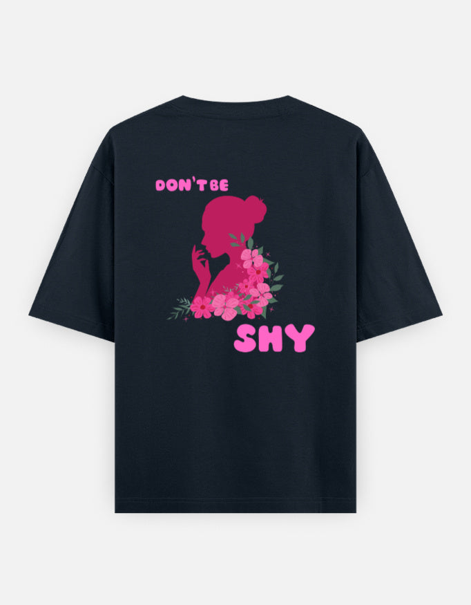 oversized unisex t shirt featuring a back print of a pink floral silhouette of a woman surrounded by blooming flowers with the words DON'T BE SHY.