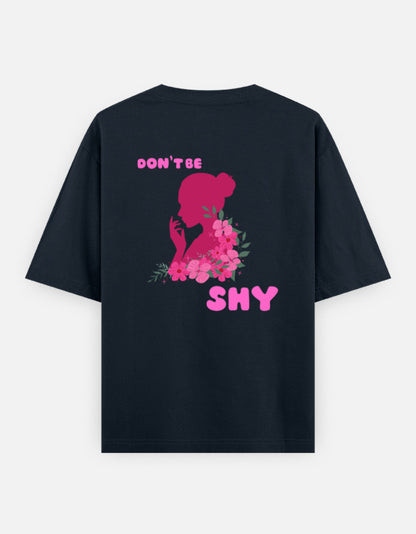 oversized unisex t shirt featuring a back print of a pink floral silhouette of a woman surrounded by blooming flowers with the words DON'T BE SHY.