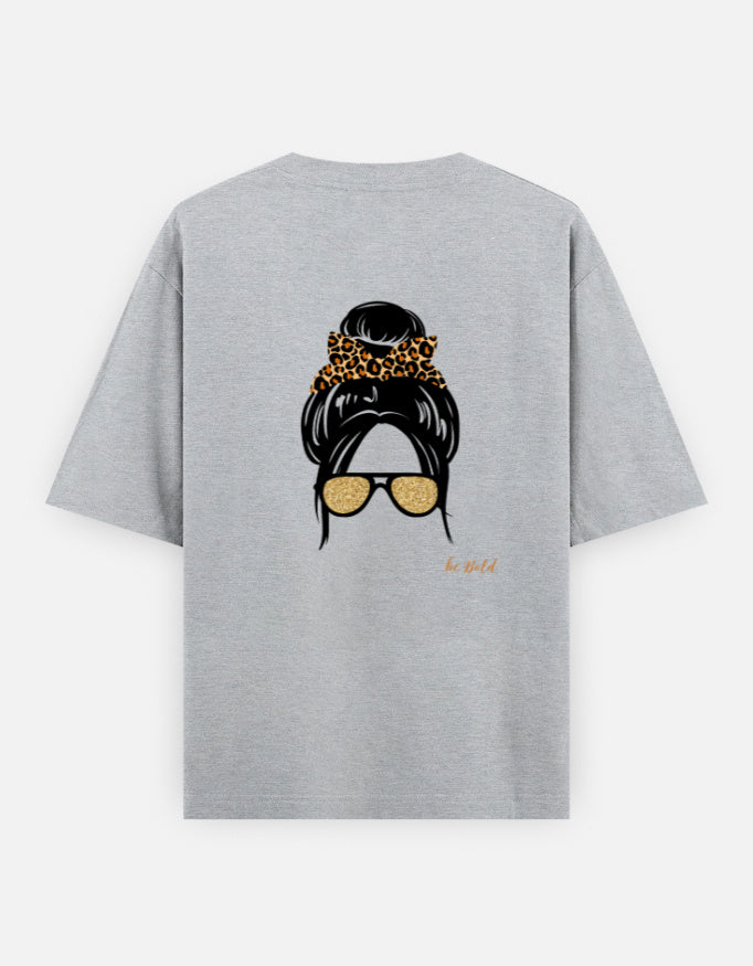 Grey oversized unisex t shirt featuring a back print of a minimalist fashion illustration with a high messy bun tied with a leopard print scrunchie and oversized gold sunglasses. Made from premium 240 GSM cotton with a relaxed streetwear fit. Available in Black and Cream by Shisha.