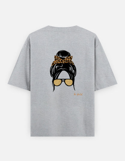 Grey oversized unisex t shirt featuring a back print of a minimalist fashion illustration with a high messy bun tied with a leopard print scrunchie and oversized gold sunglasses. Made from premium 240 GSM cotton with a relaxed streetwear fit. Available in Black and Cream by Shisha.