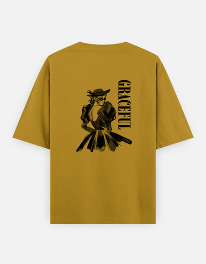 Mustord Yellow oversized unisex t shirt featuring a back print of a monochrome fashion illustration of a stylish woman wearing a hat and dress alongside vertical GRACEFUL typography. Made from premium 240 GSM 100% cotton with a relaxed oversized fit. Available in Black and Cream by Shisha.