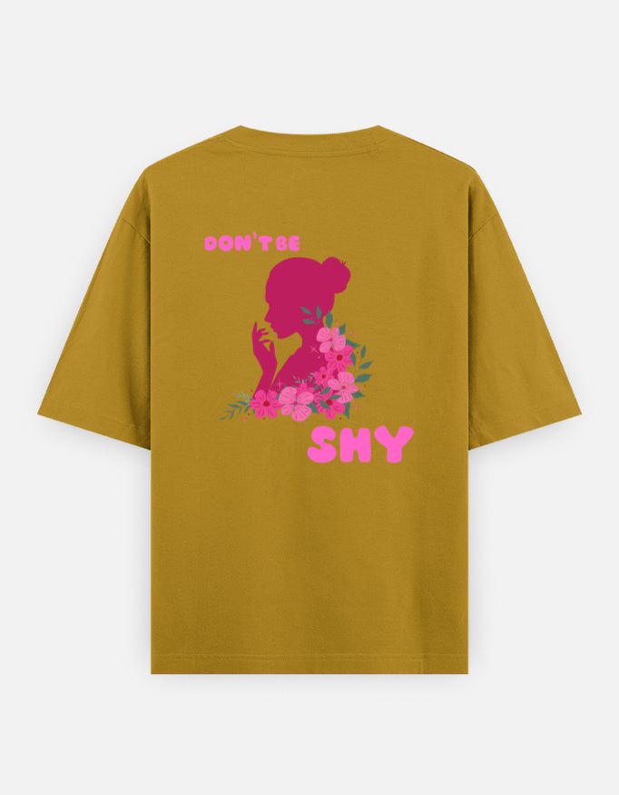 oversized unisex t shirt featuring a back print of a pink floral silhouette of a woman surrounded by blooming flowers with the words DON'T BE SHY.