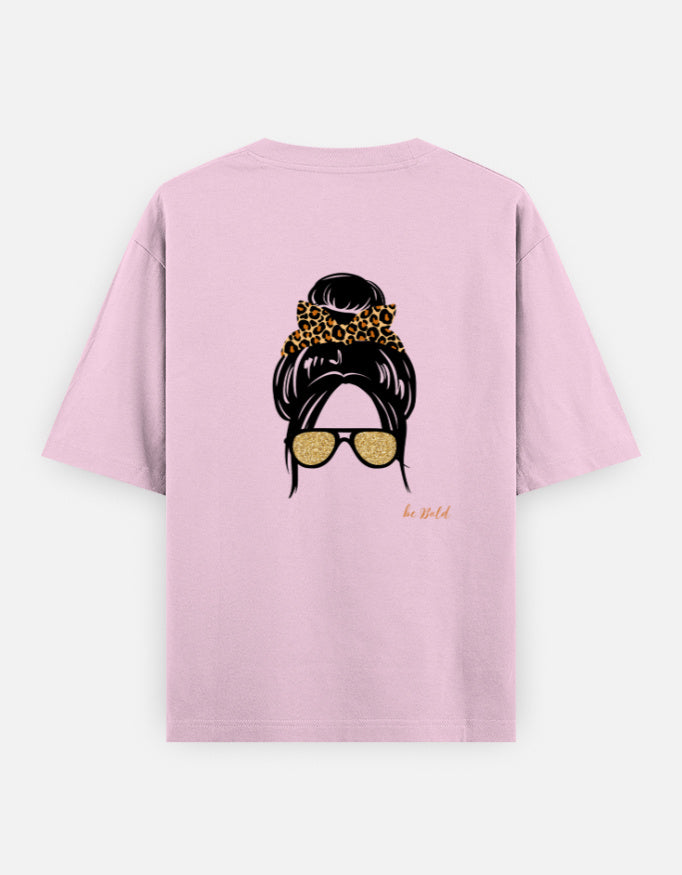Pink oversized unisex t shirt featuring a back print of a minimalist fashion illustration with a high messy bun tied with a leopard print scrunchie and oversized gold sunglasses. Made from premium 240 GSM cotton with a relaxed streetwear fit. Available in Black and Cream by Shisha.