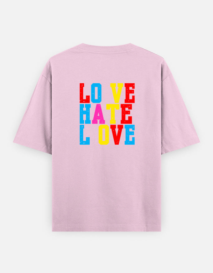Pink oversized unisex t shirt featuring a back print with stacked LOVE HATE LOVE typography in bold red, blue, yellow, and pink block lettering. Made from premium 240 GSM 100% cotton with a relaxed oversized fit. Available in Black and Cream by Shisha.