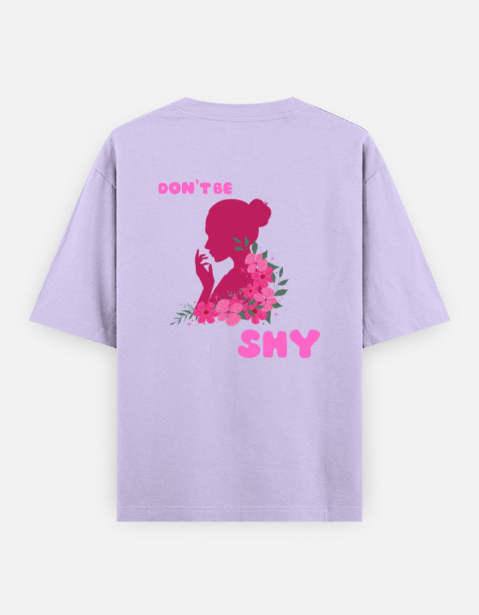 oversized unisex t shirt featuring a back print of a pink floral silhouette of a woman surrounded by blooming flowers with the words DON'T BE SHY.