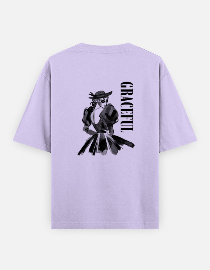 Lavender oversized unisex t shirt featuring a back print of a monochrome fashion illustration of a stylish woman wearing a hat and dress alongside vertical GRACEFUL typography. Made from premium 240 GSM 100% cotton with a relaxed oversized fit. Available in Black and Cream by Shisha.