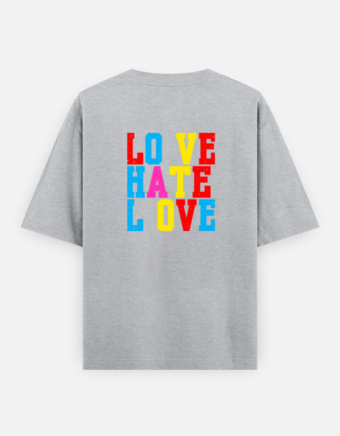 Grey oversized unisex t shirt featuring a back print with stacked LOVE HATE LOVE typography in bold red, blue, yellow, and pink block lettering. Made from premium 240 GSM 100% cotton with a relaxed oversized fit. Available in Black and Cream by Shisha.