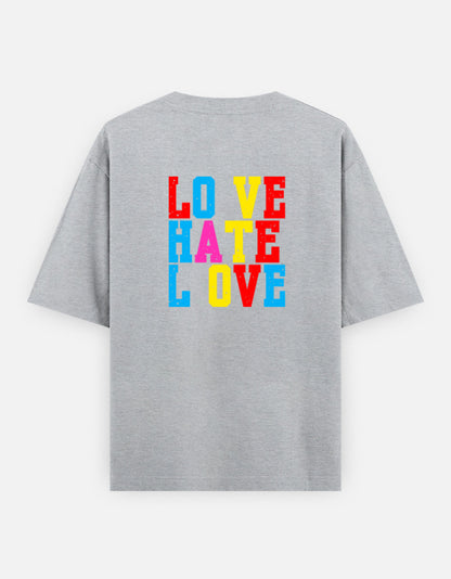 Grey oversized unisex t shirt featuring a back print with stacked LOVE HATE LOVE typography in bold red, blue, yellow, and pink block lettering. Made from premium 240 GSM 100% cotton with a relaxed oversized fit. Available in Black and Cream by Shisha.