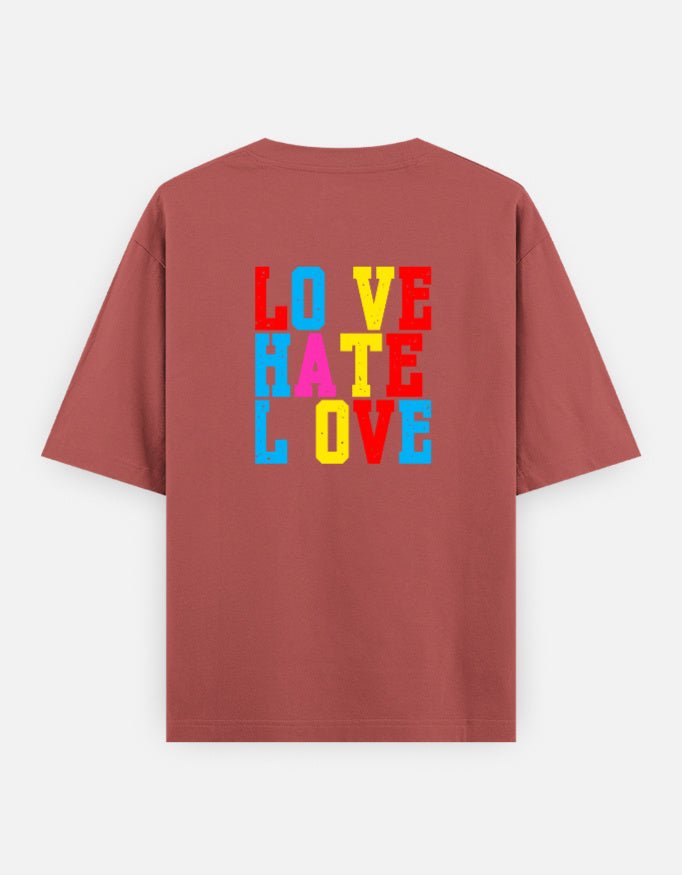 Coral oversized unisex t shirt featuring a back print with stacked LOVE HATE LOVE typography in bold red, blue, yellow, and pink block lettering. Made from premium 240 GSM 100% cotton with a relaxed oversized fit. Available in Black and Cream by Shisha.