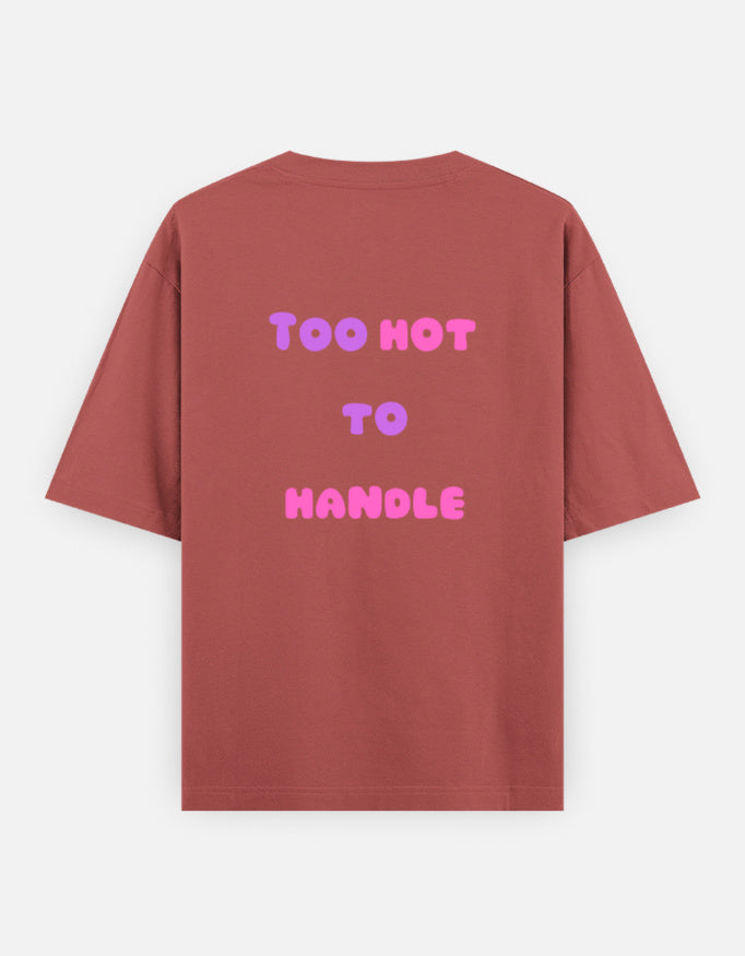 Corol oversized unisex t shirt featuring a back print with the phrase TOO HOT TO HANDLE in bold retro bubble typography with a pink and purple gradient. Made from premium 240 GSM 100% cotton with a relaxed oversized fit. Available in Black and Cream by Shisha.