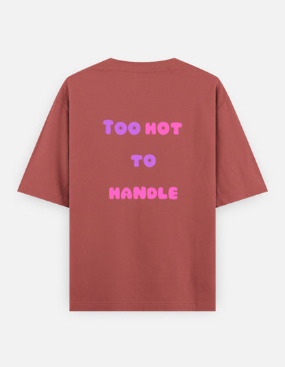 Corol oversized unisex t shirt featuring a back print with the phrase TOO HOT TO HANDLE in bold retro bubble typography with a pink and purple gradient. Made from premium 240 GSM 100% cotton with a relaxed oversized fit. Available in Black and Cream by Shisha.