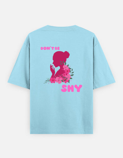 oversized unisex t shirt featuring a back print of a pink floral silhouette of a woman surrounded by blooming flowers with the words DON'T BE SHY.