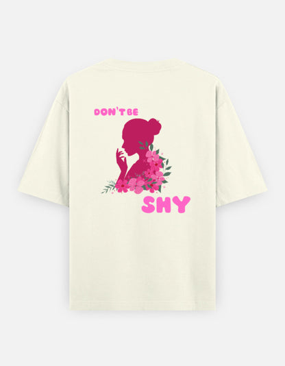 oversized unisex t shirt featuring a back print of a pink floral silhouette of a woman surrounded by blooming flowers with the words DON'T BE SHY.