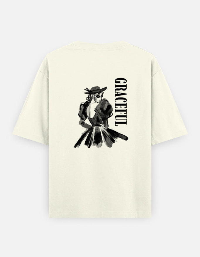 Off-White oversized unisex t shirt featuring a back print of a monochrome fashion illustration of a stylish woman wearing a hat and dress alongside vertical GRACEFUL typography. Made from premium 240 GSM 100% cotton with a relaxed oversized fit. Available in Black and Cream by Shisha.