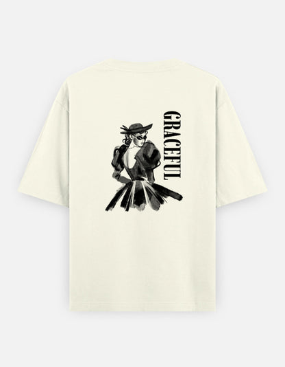 Off-White oversized unisex t shirt featuring a back print of a monochrome fashion illustration of a stylish woman wearing a hat and dress alongside vertical GRACEFUL typography. Made from premium 240 GSM 100% cotton with a relaxed oversized fit. Available in Black and Cream by Shisha.