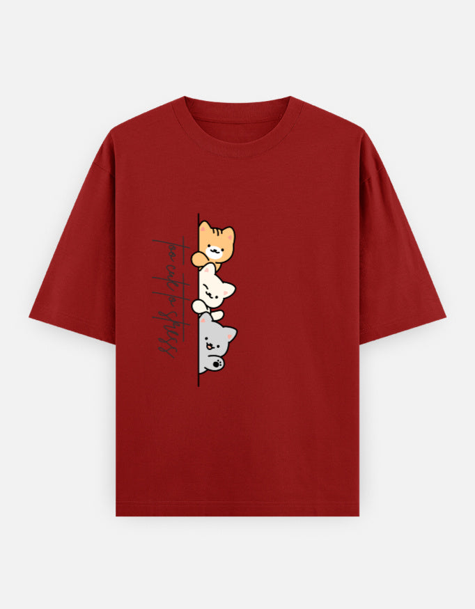 Red oversized unisex t shirt featuring a cute front print of three cartoon cats peeking from behind a vertical line with the text "perfect stress." Made from premium 240 GSM cotton with a relaxed oversized streetwear fit. Available in Black and Cream by Shisha.