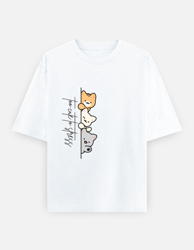 White oversized unisex t shirt featuring a cute front print of three cartoon cats peeking from behind a vertical line with the text "perfect stress." Made from premium 240 GSM cotton with a relaxed oversized streetwear fit. Available in Black and Cream by Shisha.