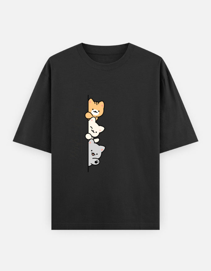 Black oversized unisex t shirt featuring a cute front print of three cartoon cats peeking from behind a vertical line with the text "perfect stress." Made from premium 240 GSM cotton with a relaxed oversized streetwear fit. Available in Black and Cream by Shisha.