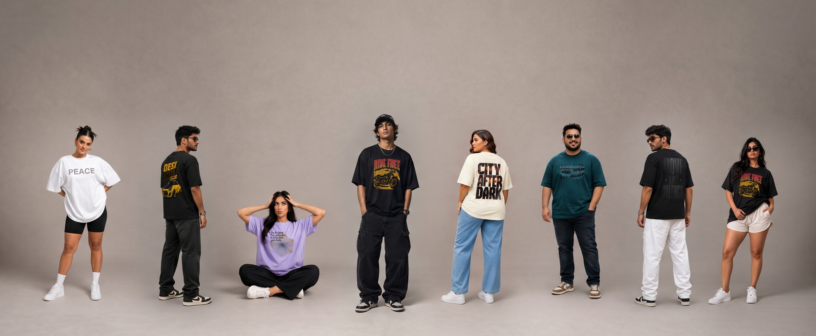 Models wearing Shisha oversized t-shirts in black, cream and teal against a studio backdrop
